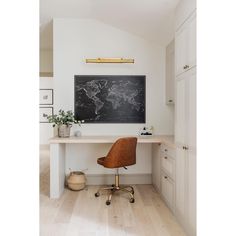 a desk with a blackboard on the wall above it