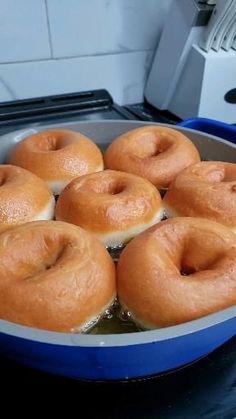 doughnuts are being cooked in a pan on the stove