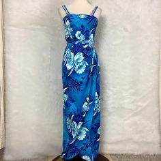 This Is A Vintage 1950s, 1960s, Sleeveless, Blue & White Orchid Floral Print, Tulip Faux Sarong Hem, Twisted Bodice, Smocked, Back Zip Maxi Dress From Paradise Hawaii. Made In Honolulu, Hawaii, Usa. Has A Built In Bodice Bra. Straps Have Tow Button Holes For Adjustment. Light Rub Wear On Hem. For Reference The Mannequin Is A Size 6-8 With Measurements Of: 34 In 26 In 35 In. Vintage Size 6. Listed Size Based On Mannequin Fit & Measurements. A Bit Tight In The Waist On The Mannequin. Polyester, Co Hawaii Usa, Button Holes, Blue Hawaiian, Honolulu Hawaii, White Orchids, Bra Straps, Sarong, Honolulu, Resort Wear