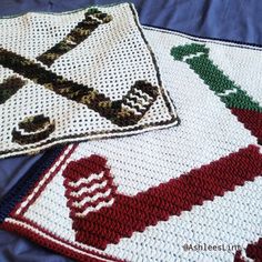 two crocheted afghans sitting on top of a bed next to each other