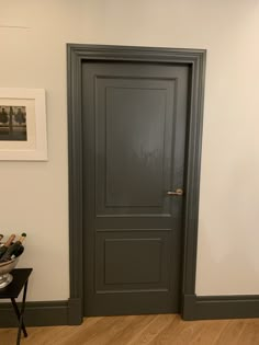 an empty room with a door and wine rack