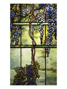 a stained glass window with grapes hanging from it