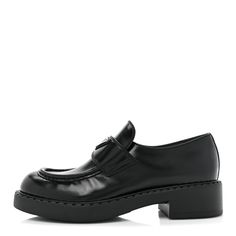 This is an authentic pair of PRADA Spazzolato Metal Triangle Logo 50mm Loafers size 38.5 in Black. These stylish loafers are crafted of black leather with black stitching, a silver Prada emblem, and rubber soles. Triangle Logo, Prada, Dust Bag, Black Leather, Loafers, Stitching, Heels, ? Logo, Silver