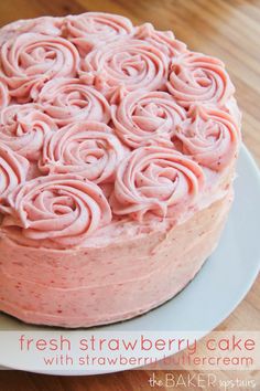 a cake with pink frosting on a white plate