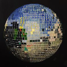 a large blue and green mosaic tile ball