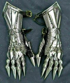 two silver metal gloves with spikes on them