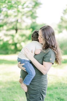 a woman holding a baby in her arms