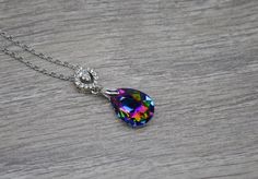 Pendant is a K-9 grade crystal in a teardrop shape. Necklaces are approximately 20 inches long. COLOR DESCRIPTION: Green- crystal is green with hints of purple, blue, pink, and yellow  Gray- crystal is a dark gray neutral tone Purple- crystal is light purple with hints of pink and blue Blue- crystal is light in the center to dark blue on the outer edges with hints of dark purple Find my shop here: https://www.etsy.com/shop/rhinestonerain Other necklaces like these found here: https://www.etsy.co Crystal Teardrop Pendant Necklace Gift, Pear-shaped Crystal Drop Necklace Gift, Teardrop Crystal Necklace Gift, Teardrop Crystal Necklace For Gift, Gift Teardrop Crystal Necklace, Pear Shape Pendant, Pear Shaped Pendant, Purple Crystal, Teardrop Pendant