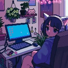 a woman sitting in front of a computer on top of a desk next to a potted plant