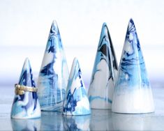 several small blue and white cones sitting on top of a table next to each other