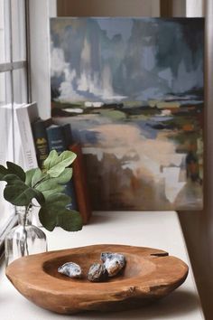 a wooden bowl sitting on top of a white counter