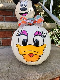 mickey and minnie pumpkins sitting on the steps