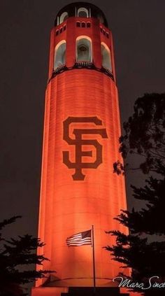 the san francisco giants tower is lit up at night