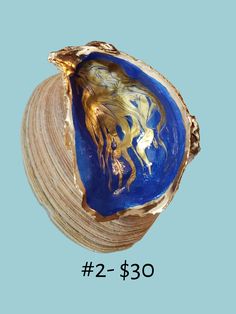 Never misplace your rings and small jewelry again with this hand painted ocean blues and gold ring dish! Oyster shells come from the beautiful East Coast. Each shell differs slightly in color and size (around 3" - 4"). No refunds or Exchanges  Gorgeous oyster shells are harvested, cleaned and hand crafted to create unique jewelry and trinket dishes. Each shell is one of a kind! Please indicate your design preference at check out:) All of our oyster dishes have been individually hand selected and embellished. These one of a kind creations are not mass produced in a factory and as a result, each shell dish will have subtle variations from one another. Beautiful variations are due to hand gilding, the unique natural variations in the shape and size and resting angle of the sea shells that are Handmade Blue Shell Gift, Gold Ocean-inspired Shell For Jewelry Making, Oyster Dishes, Blue Ocean-inspired Shell As Gift, Blue Ocean-inspired Shell As A Gift, Bohemian Shell Oyster Bracelet, Ocean-inspired Shell Oyster Bracelet Jewelry, Oyster Shell Jewelry, Oyster Trinket Dish