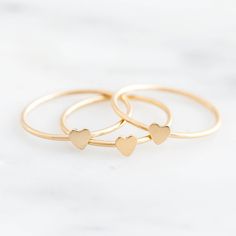 Our Heart Stacking Ring might be the sweetest stacking ring there is. You’ll never want to take this little gem off - and you won’t have to! Made of gold filled, perfect for everyday wear! Find more dainty rings & jewelry at Simple & Dainty. Dainty Stackable Heart Ring Gift, Dainty Heart-shaped Stackable Rings For Gifts, Dainty Heart-shaped Stackable Rings As Gift, Dainty Heart Charm Stackable Gift Rings, Dainty Stackable Gift Rings With Heart Charm, Simple Heart-shaped Stackable Rings As Gift, Simple Heart-shaped Stackable Rings For Gifts, Simple Heart Shaped Stackable Rings For Gifts, Delicate Heart Charm Ring As Gift