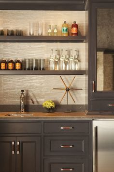 a kitchen with black cabinets and stainless steel appliances