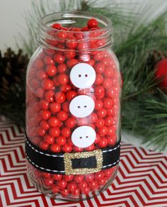 a glass jar filled with red and white candies