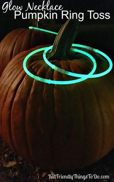 two pumpkins with glow rings on them and the words glow neckless pumpkin ring toss