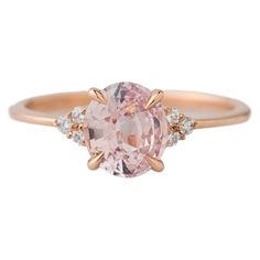 This elegant 14K rose gold knife-edge style ring features a stunning and unheated 1.41-carat oval peachy-pink sapphire at its center, certified by the GIA for its quality and authenticity. Flanking the sapphire are six round brilliant cut diamonds, adding a touch of brilliance and sophistication to the overall design. The combination of vibrant pink sapphire and sparkling diamonds creates a striking and classily understated piece that is sure to captivate attention. Center stone: 1.41 carats natural, no heat pink sapphire Center stone measurements: 7.40 x 6.54 x 3.75mm Accent stones: 6 round brilliant cut diamonds, 0.08 approximate total carat weight, G/VS2-SI1 Size 6, and sizeable. 14K rose gold, stamped with maker's mark Sapphire Diamond Engagement Ring, Diamond Sapphire Engagement Ring, Sapphire Diamond Engagement, Peachy Pink, Sapphire Diamond, Jewelry Rings Engagement, Sparkle Diamonds, Round Brilliant Cut Diamond, Cluster Ring