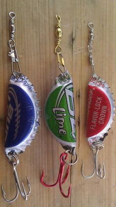 three soda bottle caps with fishing hooks hanging from them