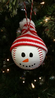 a snowman ornament hanging from a christmas tree