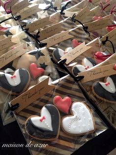 many decorated cookies are on display in plastic bags with thank you notes attached to them