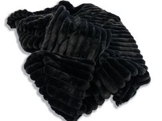 a pile of black fur sitting on top of a white floor