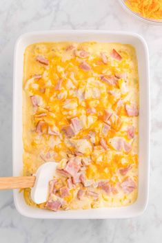 a casserole dish with ham and cheese in it