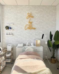 a white brick wall in a room with a bed, desk and other items on it