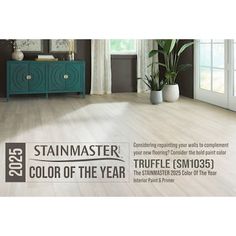 a living room with wood floors and white curtains on the window sill is featured in this ad for stainmaster