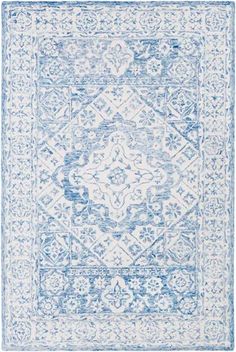 a blue and white rug with an intricate design