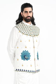 A dewy mist coloured Rajasthani inspired peacock motif hand embroidered nehru jacket with a cowl draped kurta made of bamberg raw silk. Paired with white slim fit Pant Pajama. Color of the actual garment may vary due to lighting conditions during the shoot.

Size Chart For Men





	
	
					Men's Size Chart
		

		
		
						
				Size Chart For Men
				Custom Size Measurement Guide
			
			
				
				
				Custom Size Measurement Guide
1. Take your measurements at ease…don’t hold your breath!
2. Be a Embroidered Nehru Jacket For Traditional Ceremonies, Traditional Raw Silk Nehru Jacket, Designer Silk Nehru Jacket With Zari Work, Designer Nehru Jacket With Cutdana For Festive Occasions, Festive Designer Nehru Jacket With Cutdana, Designer Nehru Jacket With Resham Embroidery In Raw Silk, Traditional Nehru Jacket In Raw Silk With Intricate Embroidery, Festival Nehru Jacket With Intricate Embroidery In Raw Silk, Traditional White Raw Silk Nehru Jacket