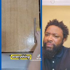 a man with a beard standing in front of a microwave