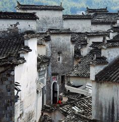 an aerial view of the roofs of old buildings