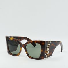 Step out in style with these Saint Laurent SLM119 BLAZE 002 sunglasses in Dark Havana/Green. These luxurious frames are the perfect accessory to elevate any outfit, whether you're hitting the streets or lounging by the pool. The Havana frame color adds a touch of sophistication, while the green lenses provide a pop of color that will make you stand out from the crowd. With a lens socket width of 53 and a bridge size of 19, these sunglasses are the perfect fit for any face shape. Saint Laurent is Luxury Brown Shield Sunglasses With Square Frame, Designer Cat Eye Tinted Sunglasses, Designer Brown Shield Sunglasses With Polarized Lenses, Designer Brown Shield Sunglasses With Gradient Lenses, Designer Brown Shield Sunglasses With Tinted Lenses, Designer Sunglasses With Gradient Square Frame, Designer Sunglasses With Square Frame And Gradient Lenses, Designer Brown Sunglasses With Mirrored Lenses, Designer Cat Eye Sunglasses With Mirrored Square Frame