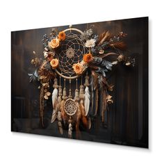 an image of a dream catcher with flowers and feathers on it's back wall