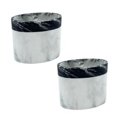 two silver and black marble candle holders on a white background, one is turned upside down