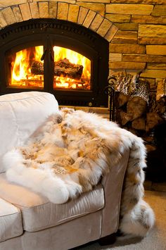 a white couch sitting in front of a fire place