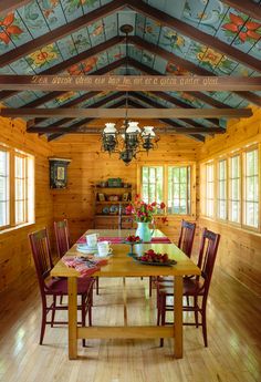 a dining room with wooden walls and ceiling