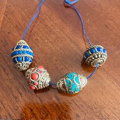 Price is only for one bead!! Measurement: B1 - Coral inlaid bead 20X15mm, hole size 1mm, 0.3oz weight B2 - Lapis inlaid bead 18X19mm, hole size 1mm, 0.3oz weight B3 - Turquoise / Coral inlaid bead 20X16mm, hole size 1mm, 0.30oz weight B4 - Lapis inlaid bead 23X18mm, hole size 1mm, 0.3oz weight Beautiful multiple colors handcrafted beads from Nepal. Great additions to your necklaces and bracelets making projects. Tibetan beads are very unique and still unlike made in China, every individual beads Blue Bohemian Beaded Bracelets With Large Beads, Blue Bohemian Jewelry With Large Beads, Blue Spacer Beads For Festivals, Traditional Blue Oval Beads Jewelry, Traditional Blue Oval Beaded Jewelry, Bohemian Large Blue Beads, Blue Beaded Bracelets For Festival With Polished Beads, Blue Polished Beaded Bracelets For Festivals, Bohemian Blue Beaded Bracelets With Oval Beads