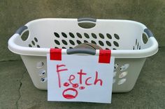 a white basket with a sign attached to it that says fetch on the front and side