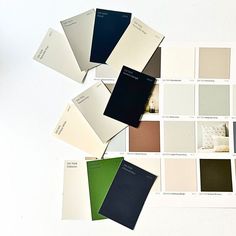 several different shades of paint on a white surface with the same color swatches in front of them