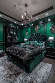 a bedroom with green walls, black furniture and a chandelier hanging from the ceiling