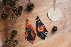 the beaded earrings are next to pine cones