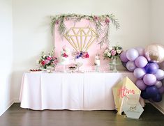 a table topped with balloons and cake