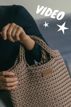 a woman holding a brown knitted bag with white stars on the bottom and text overlay that reads, video