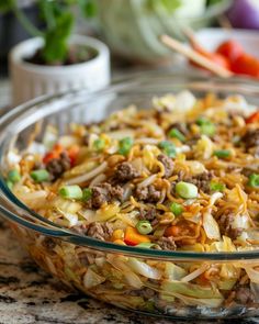 a glass bowl filled with food on top of a table