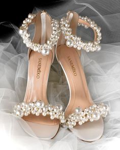 a pair of shoes with pearls on them