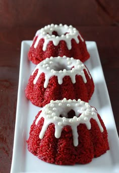 two red velvet cakes with white icing on a plate, ready to be eaten