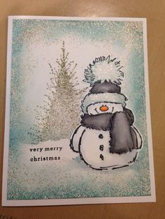 a card with a snowman wearing a hat and scarf